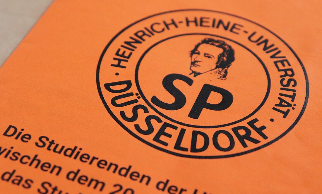 Das Logo des Studierendenparlaments ist auf orangenem Grund zu sehen. 