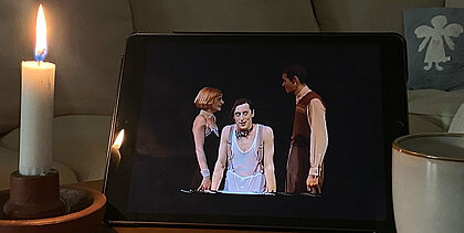 Auf dem Bild sieht man ein Ipad mit dem Musical das Musical „Cabaret“. Daneben steht eine Kerze 