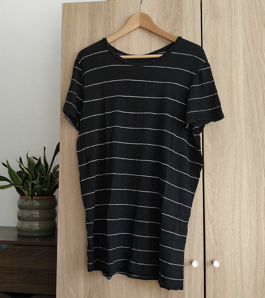 Zu sehen ist ein schwarzes, lockeres T-Shirt.